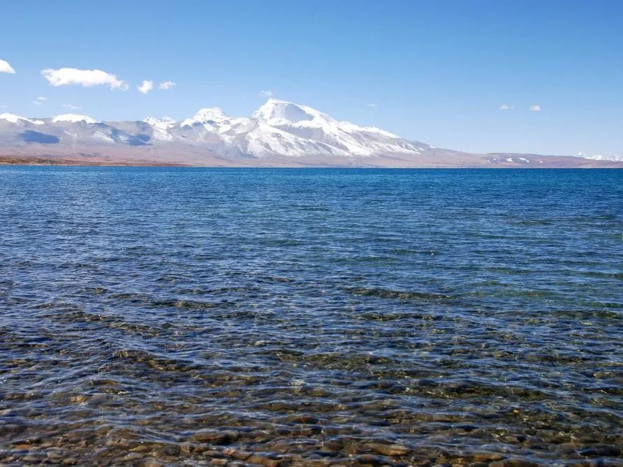 Lake Manasarovar with distant snow-capped mountains