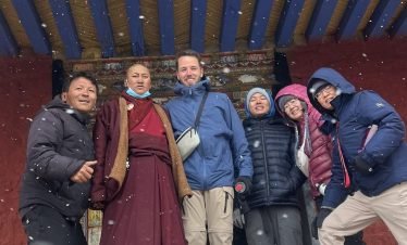 Tourists take photos with monks