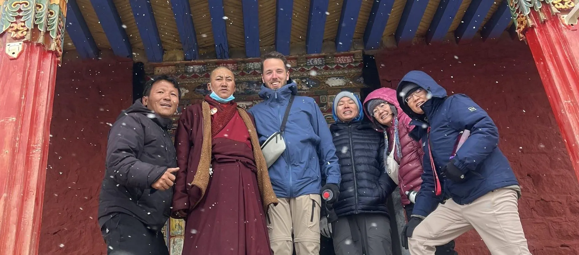 Tourists take photos with monks