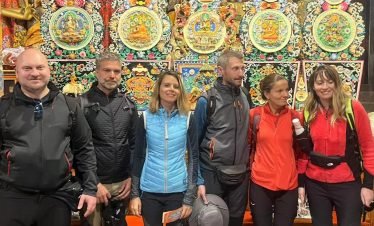 Tourists take a group photo while hiking in Tibet