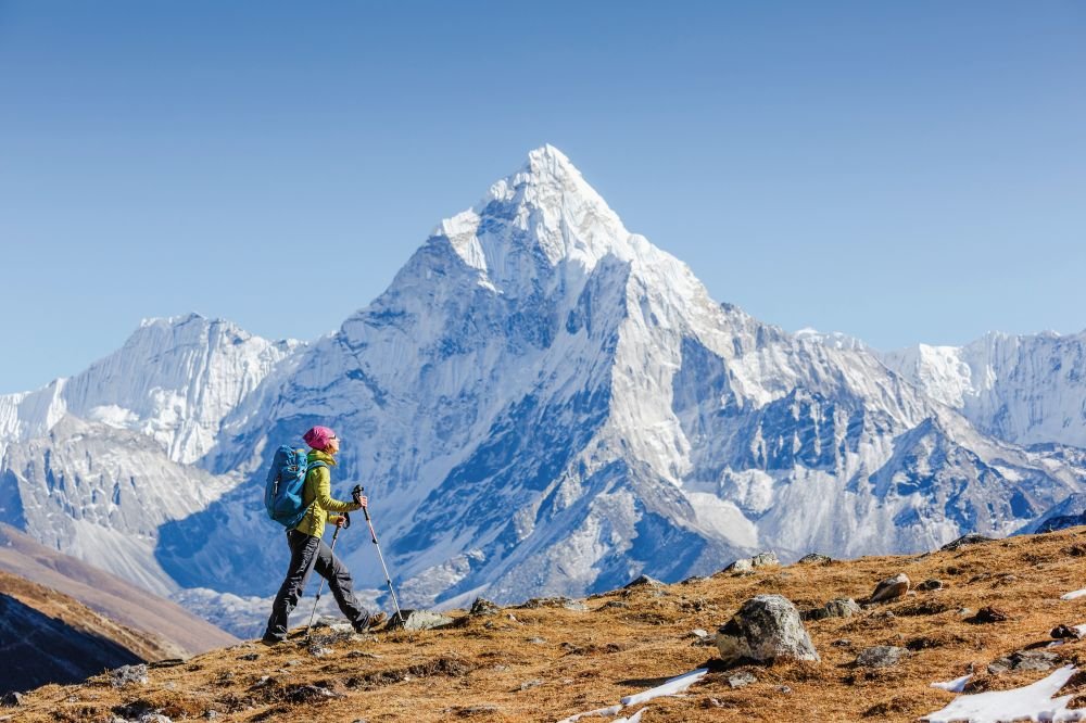 Hiker near Everest Base Camp with snow-covered mountains