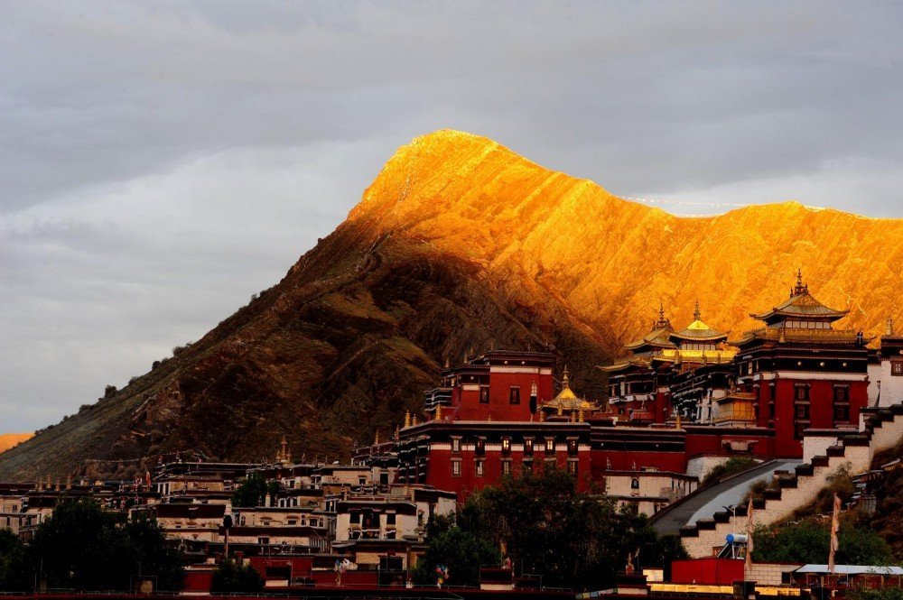 Tashi Lhunpo Monastery at sunset with mountains