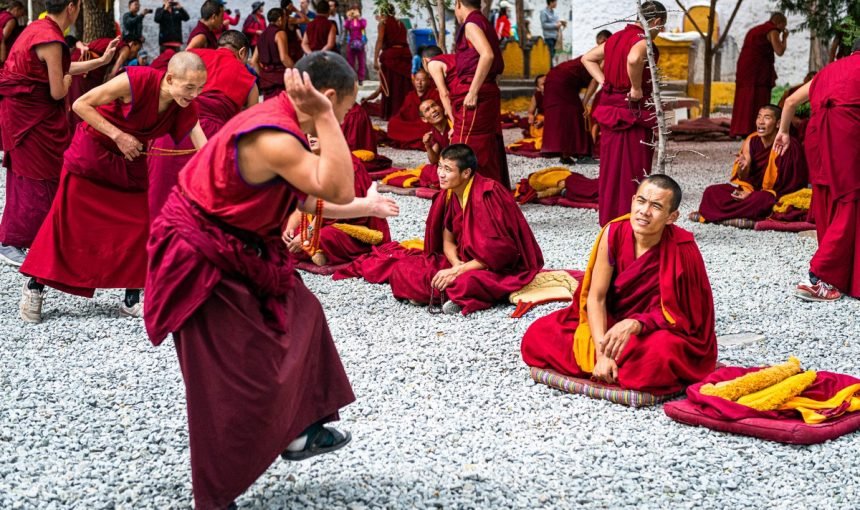 Why do Buddhist Monks wear Orange Robes and Shave their Heads?